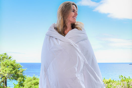 woman wrapped in an hungarian goose down summer duvet